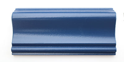 A piece of trim painted blue using a satin paint.