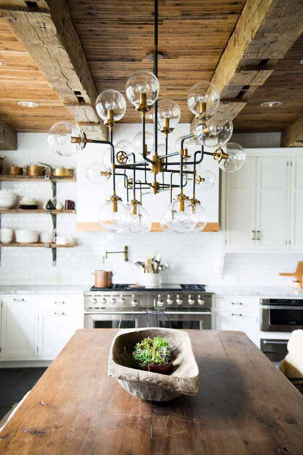 The industrial style of pendant light balls clustered above a massive wooden table I ZenQ Designs