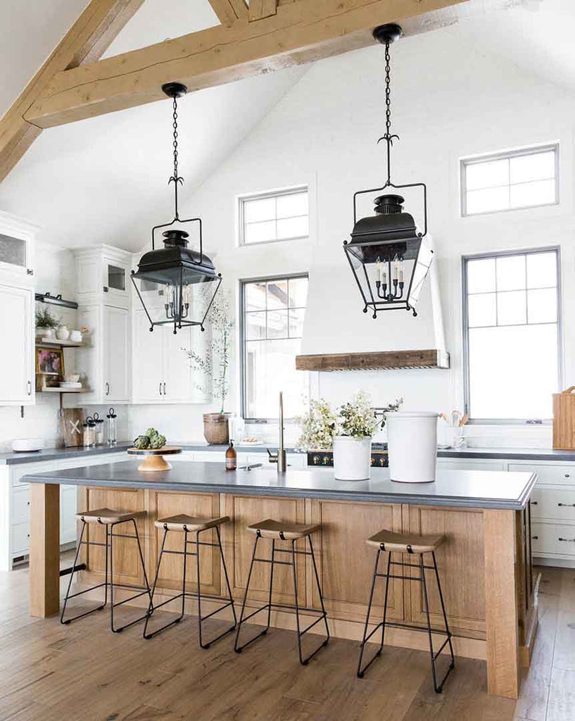 Two iron pendant lanterns above the wooden counter in a rustic kitchen I ZenQ Designs