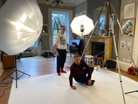 two men on a photo shoot backdrop looking at the camera 