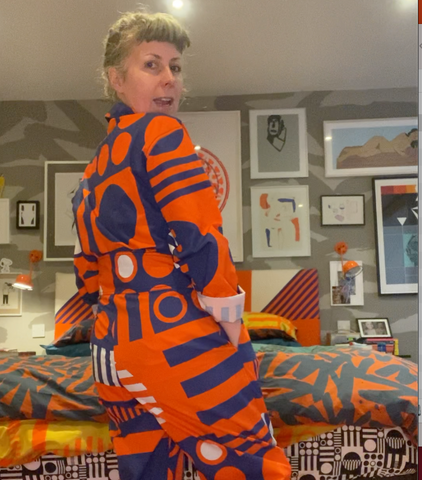 grainy image of Jolene in the paradox tricolor classic pyjama suit, demonstrating the fit 
