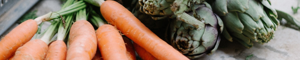 An image of couple of carrots and some vegetables