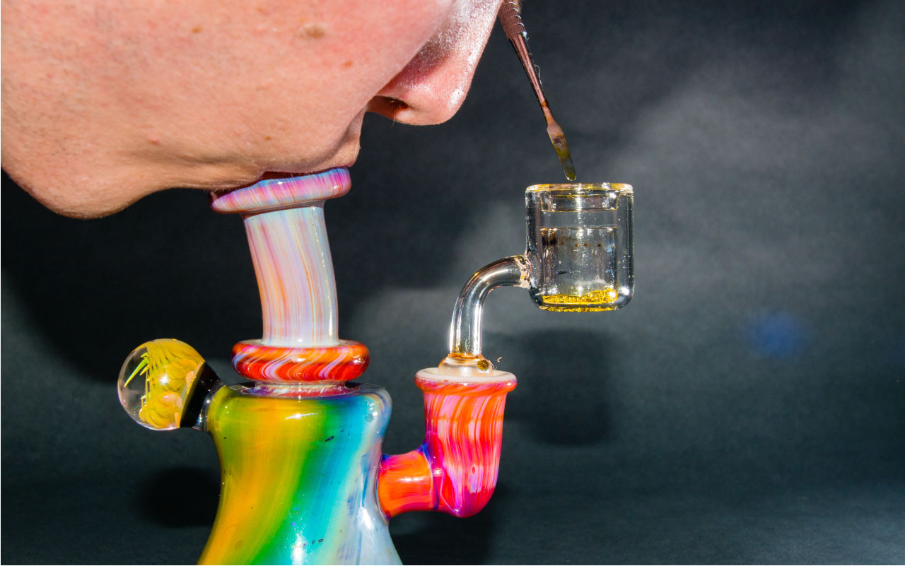 Image of person hitting a dab rig.