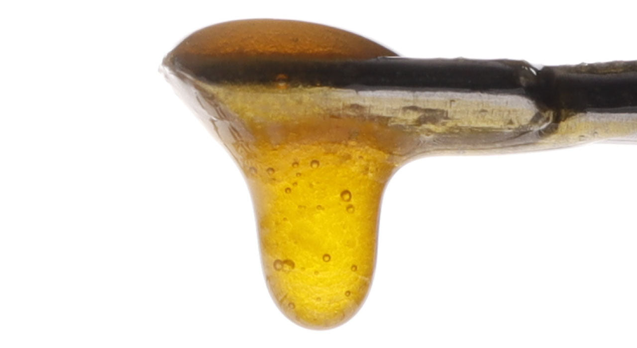 image of Sour Suver Haze CBD Live Resin dripping from dab tool