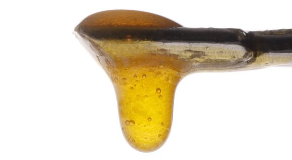 Image of Sour Suver CBD Live Resin dripping from a dab tool