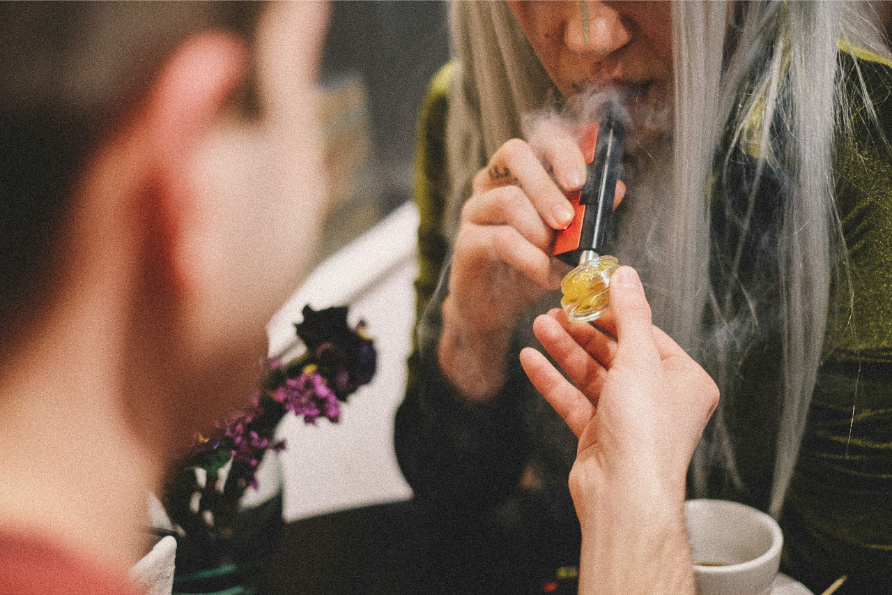 Image of woman vaping CBD shatter