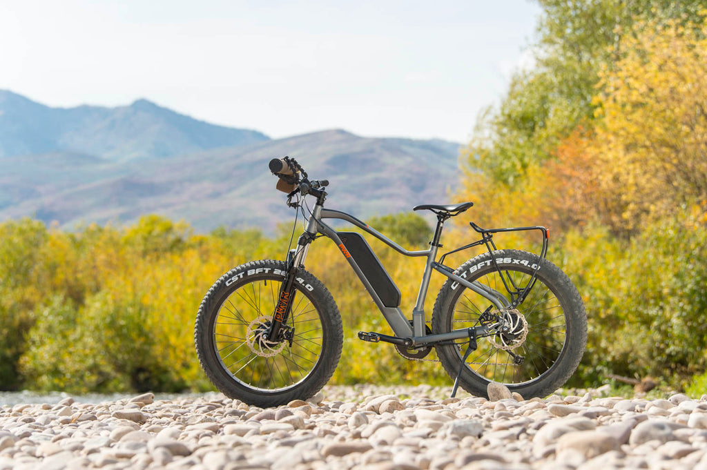 PWR Dually e-bike on a rocky beach