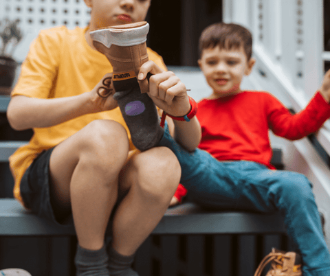 kids helping each other put on socks