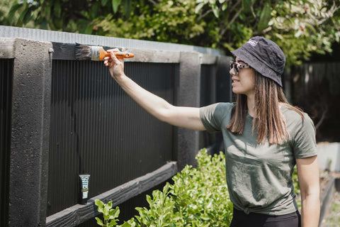 Georgia from Moochstyle painting her Christchurch fence using Haydn's Leeda Brush