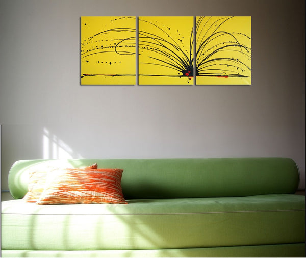 canvas triptych painting in yellow on a grey wall 