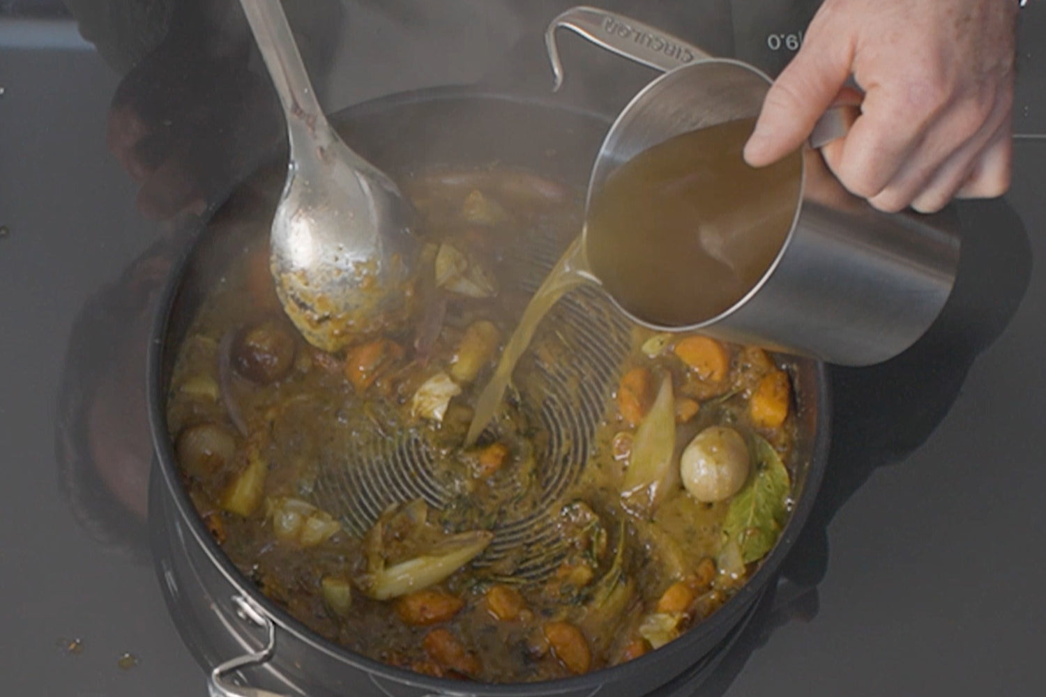 Marcus deglazes his pan with chicken stock