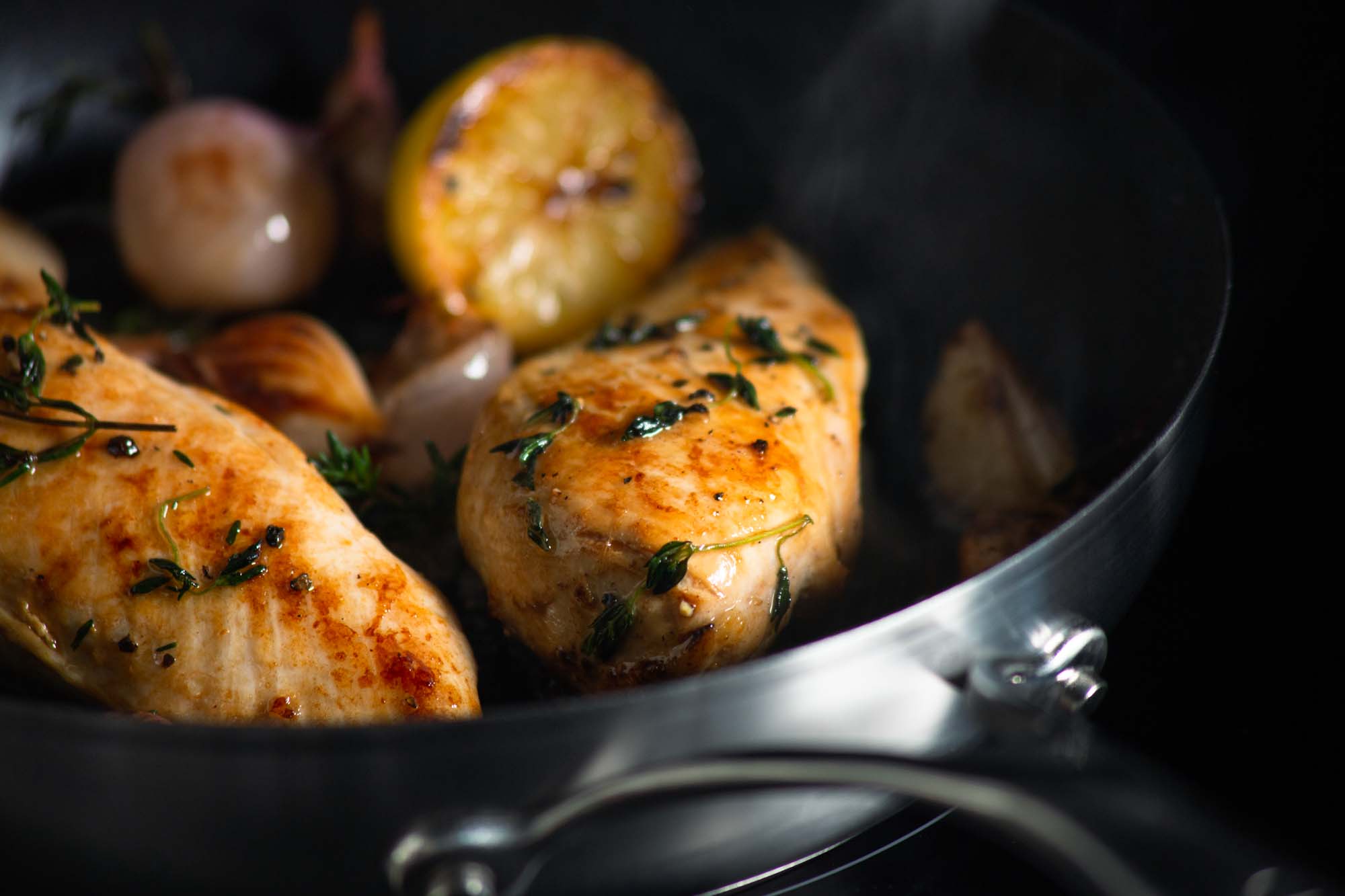 Chicken with herbs being cooked in a Circulon frying pan