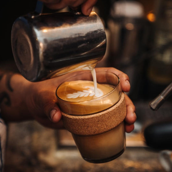 Coffee artisan making a cappuccino