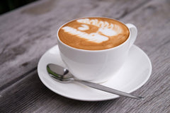 A cappuccino on a cafe table. Image Credit: JackBuu/iStock/Getty Images