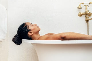 woman relaxing in bath - pre-sleep routine