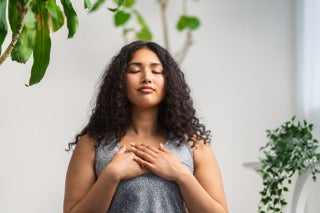 woman doing relaxaing breathing exercises