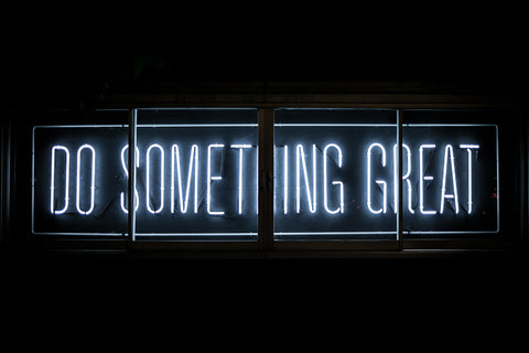 Neon text "Do Something Great" on a dark background.