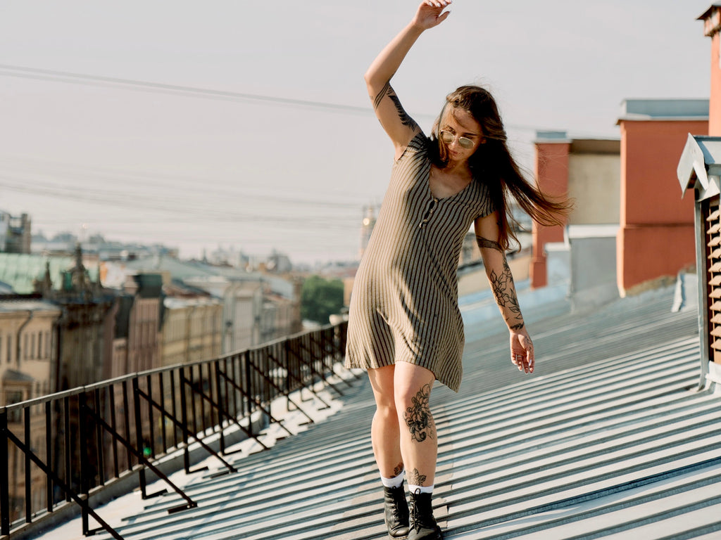 Woman Balancing on Rooftop Lastics Blog From Stiff and Tight to Loose and Flexible