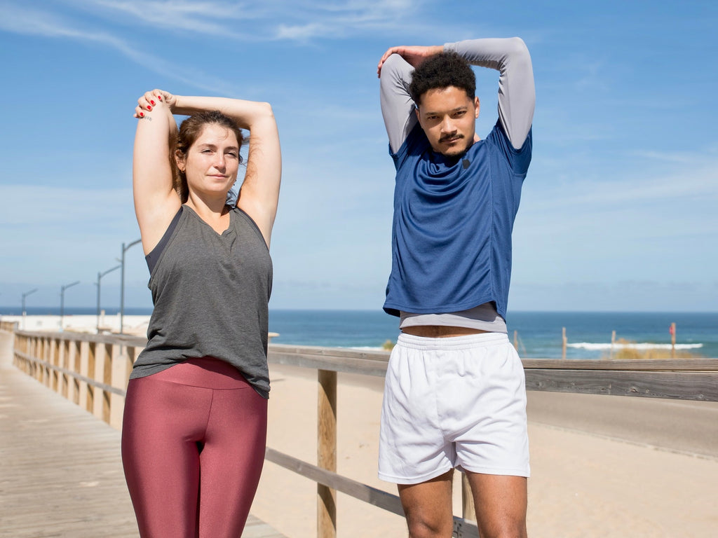 Couple Stretching Triceps 30 Seconds on Beach