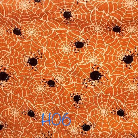 black spiders on white web on orange background