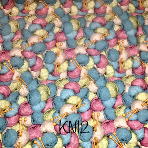 blue, pink and cream yarn balls on aqua