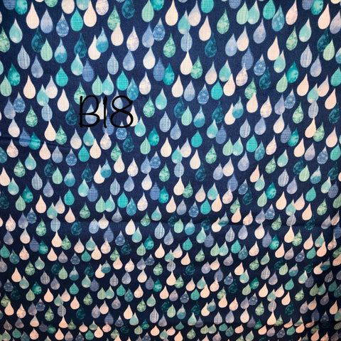 multi-coloured rain drops on blue background