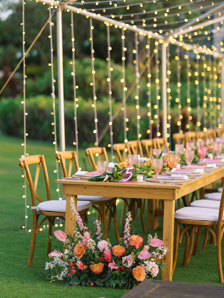 reception space with fairy garden lights and wooden tables