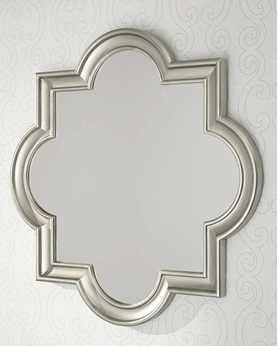 Mirror with shapely quatrefoil frame abd brushed champagne finish