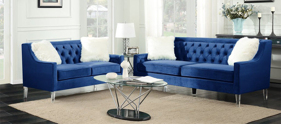 Velvet navy blue sofa with white accent pillows