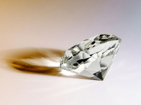 Shiny diamond casting a shadow.