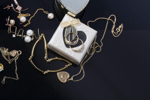 Gold fashion jewelry displayed on black background