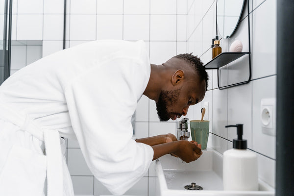 man applying water to his beard