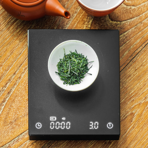 Weighing tea leaves on a scale