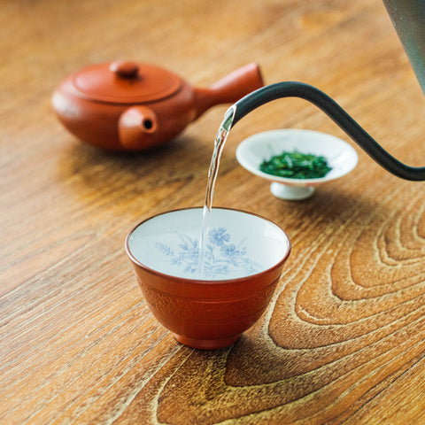 Pouring hot water into a teacup