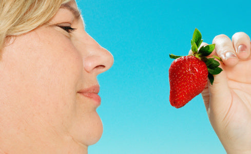 Woman holding a strawberry