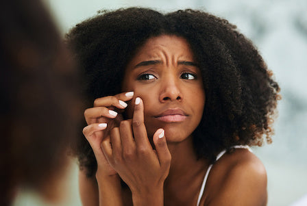 Woman checking her acne and blemishes