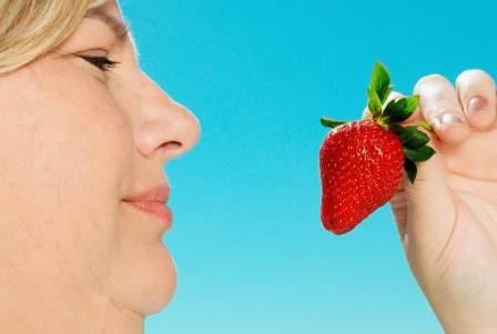 Woman holding a strawberry