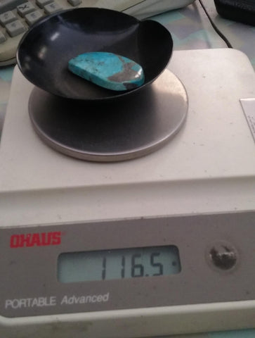 natural turquoise being weighed