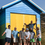 Summer must haves. A selection of bamboo shirts being worn by a group of men in front of a beach hut in Brighton VIC