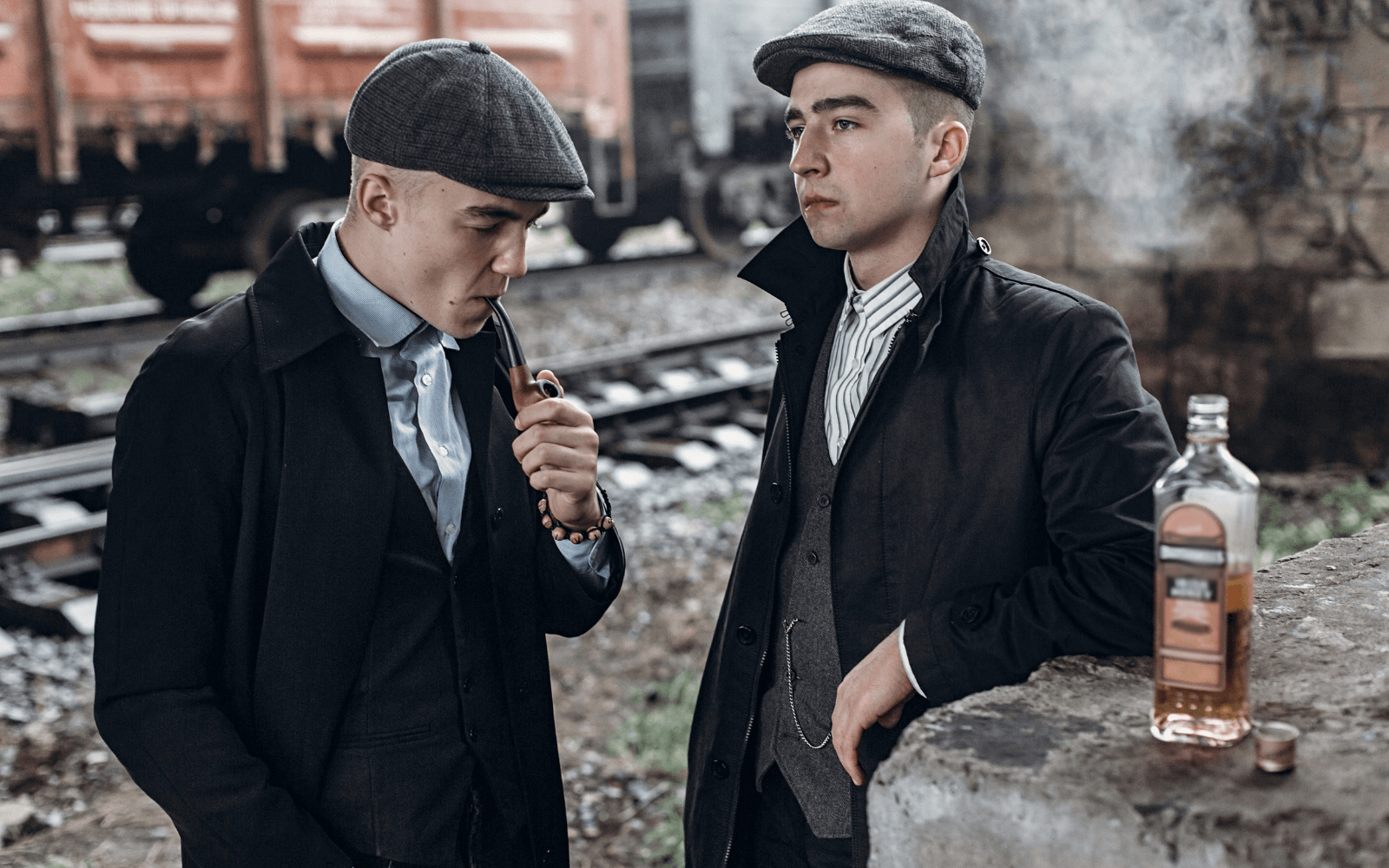A photo from the TV series, Peaky Blinders showing 2 of the actors wearing flat caps.