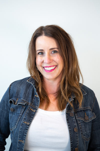 Woman in denim jacket and white shirt