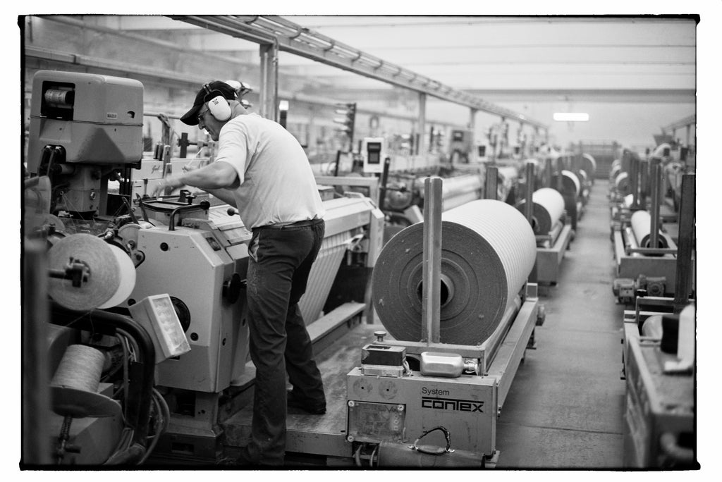 A worker in Barn & Willow's Belgian Linen factory 