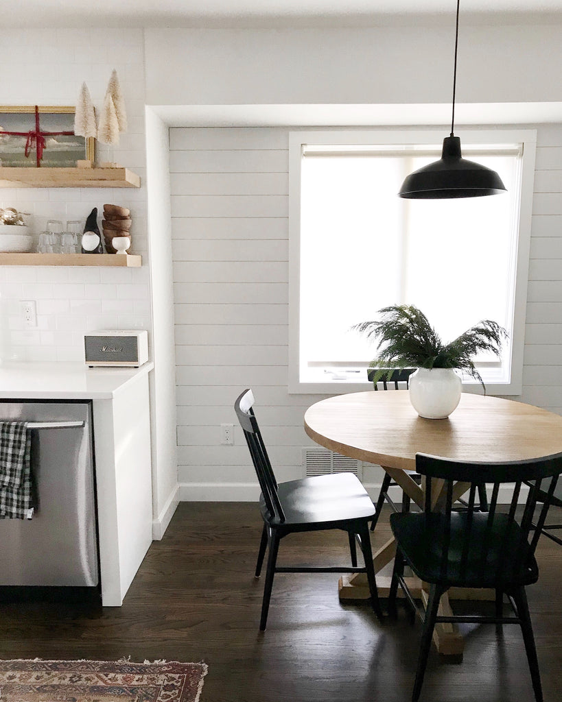 A minimalist white interior kitchen with open shelves.