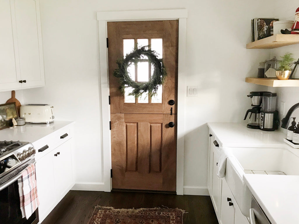 Medium wooden kitchen door with a holiday wreath 