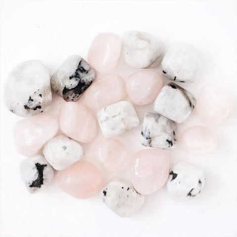 Rose Quartz and Moonstone crystals against a white background. They are some of the best crystals for menopause healing.