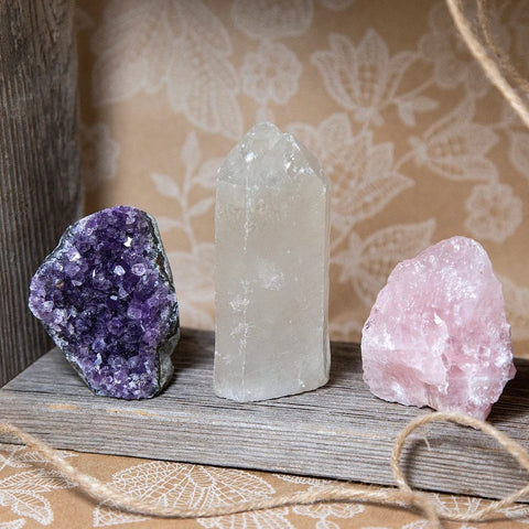 Several crystals are pictured alongside amethyst include Rose Quartz and Clear Quartz