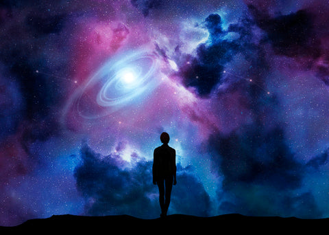 Man stands against a fantasy backdrop depicting the cosmos.