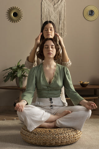 A woman undergoing a Reiki energy healing session.