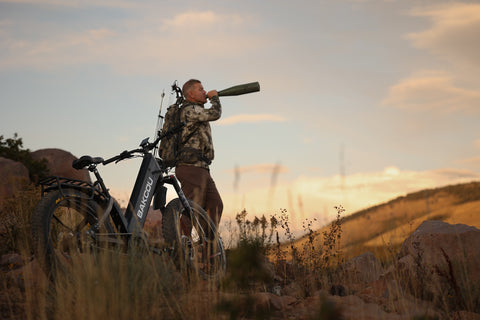 Man Bugling Behind a Bakcou Hunting Electric Bike