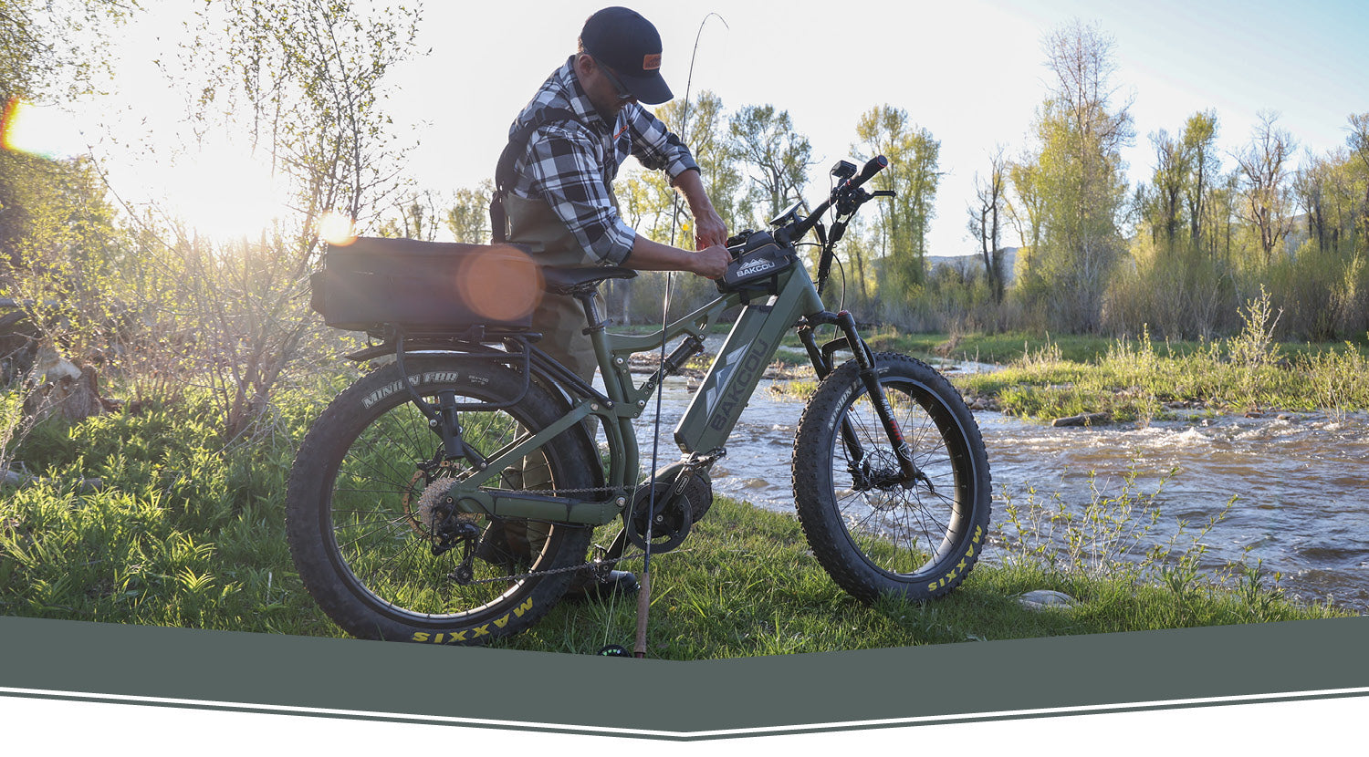 BAKCOU AFFILIATE PROGRAM - Guy standing by Bakcou bike adjusting accessories, by a river, getting ready to fish